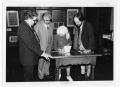 Photograph: [Irene Salce de Urbina signing a book with Tom Kreneck and others]