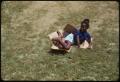 Photograph: [Child Sliding Down Berm at Institute of Texas Cultures]