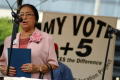 Photograph: [Adelfa Callejo speaking at a voting promotion event]