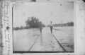 Photograph: [Photograph of Men Walking on Flooded Railroad Track]