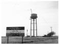 Photograph: [Water tower construction with site sign]