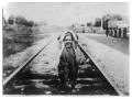 Photograph: [Unidentified Child on Railroad Tracks]