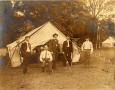 Photograph: Railroad Survey Crew Poses in Front of Tent, c. 1902
