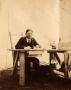 Photograph: J. O. Schulze at Desk in Tent, c. 1902