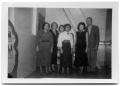 Photograph: Five women and a man standing in the back of a corridor