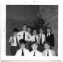 Photograph: Group of school boys standing in the corner of a classroom