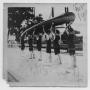 Photograph: [Six Men in Bathing Suits Carrying a Canoe]