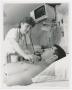 Photograph: [Woman Standing Over Patient]