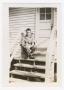 Photograph: [Robert Ariniello Sitting at the Top of Barracks Steps]