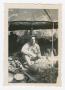 Photograph: [Soldier Sitting Under a Tent]