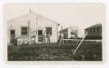 Photograph: [Soldiers Standing Around Buildings at Camp Campbell]