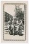 Photograph: [Three Soldiers Sitting by Frisco Railroad Building]