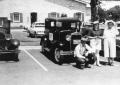 Photograph: [Family standing in front of antique car]