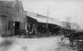 Photograph: [Blacksmith shop with buggies out front]