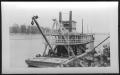 Photograph: [Boat near a river bank. Location unknown.]