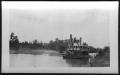 Photograph: [A Boat Located Close to River Bank. Location Unknown.]
