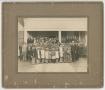 Photograph: [Photograph of a Group of People Standing in Front of a Building]