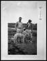 Photograph: Man, Women, Child and Dog in  Field