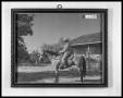 Photograph: Man on Horse in Front of Ranch House
