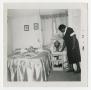 Photograph: [L. B. Allen Arranging a Bedroom]