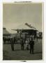 Photograph: [People standing Outside of a Train Station]