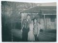 Photograph: [Roger Cook, Muriel June, and Jimmy Perdue by a House]