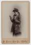 Photograph: [Young Woman Wearing an Overcoat]
