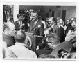 Photograph: [Lyndon Johnson Surrounded at a Podium]