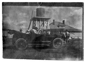 Primary view of [People in a Car near a Water Tower]