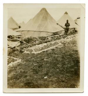 [Photograph of Soldier Standing by Tents]