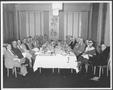 Photograph: [Albert Peyton George and a group of men in the dining room of a Hous…