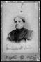 Photograph: ["Mrs. Belle R Davis" wearing a dress with puffed sleeves and large s…