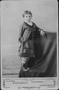 Photograph: [Young girl standing on a covered platform]