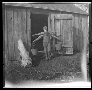 Primary view of [Photograph of Young Man Carrying Buckets]