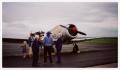 Photograph: [Photograph of Helen Snapp with News Crew and Plane]