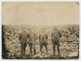 Photograph: [Photograph of Four Soldiers in Front of a Rock Wall]