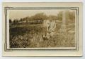 Photograph: [Photograph of a Girl in Front of a Grave]