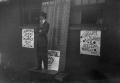 Photograph: [Man on Box With Signs]