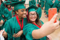 Photograph: [Two Students Taking Selfie At Graduation Ceremony]