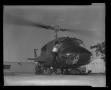 Photograph: [Photograph of a man climbing into a YUH-1D Iroquois helicopter]
