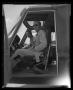 Photograph: [Photograph of two men sitting in the cockpit of a YUH-1D Iroquois he…