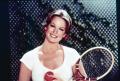 Photograph: [Phyllis George holding a tennis racquet]