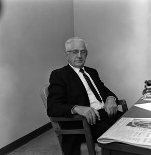 Primary view of [Dr. Dickie sitting at desk, 1 of 3]