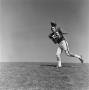 Photograph: [Football player #83, Barry Moore, catching a pass]