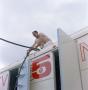 Photograph: [Man on top of WBAP truck]