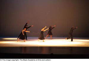 Primary view of [Photograph of five dancers performing a dance on stage in black outfits]