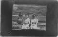 Photograph: [Three women sitting together on a bench]