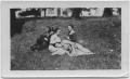 Photograph: [Four women lying outside in the sun]