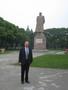 Photograph: [Man poses with Mao Zedong statue at Fudan University]