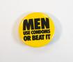 Photograph: [Men Use Condoms or Beat It Button, undated]